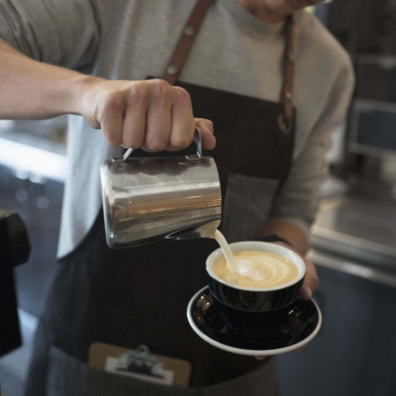 20190529191242-GettyImages-753289793 pouring milk into coffee