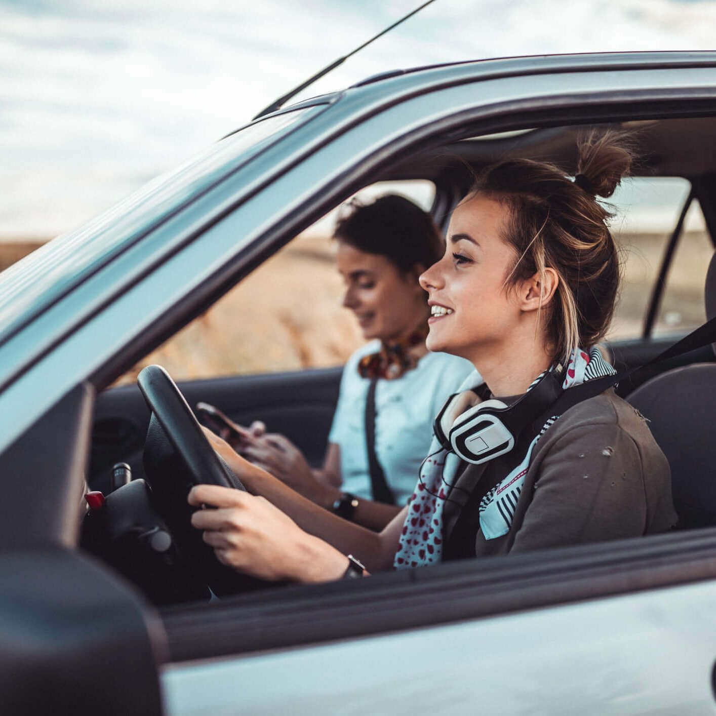 girl smiling while driving